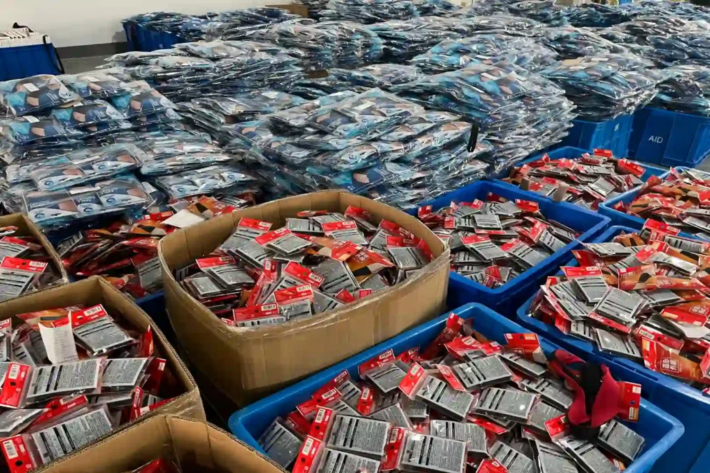 Large batches of sports brace products organized in retail packaging and clear bags before final packing and shipment.