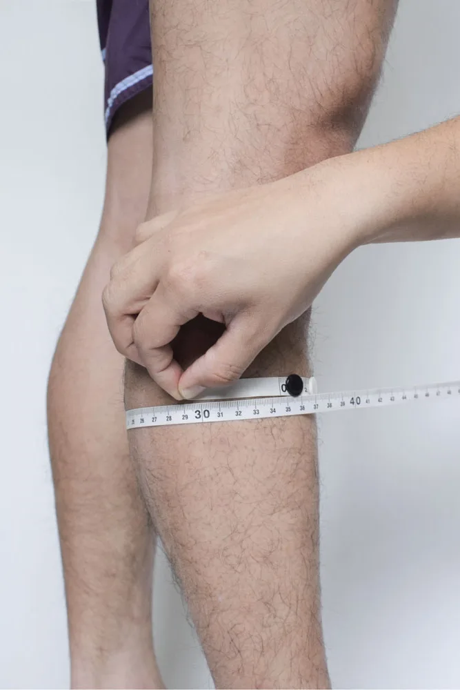 Manual measurement of calf circumference with tape measure for sizing